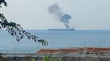 This handout picture released on April 24, 2021, shows smoke billowing from a tanker off the coast of the western Syrian city of Baniyas. (SANA/AFP)