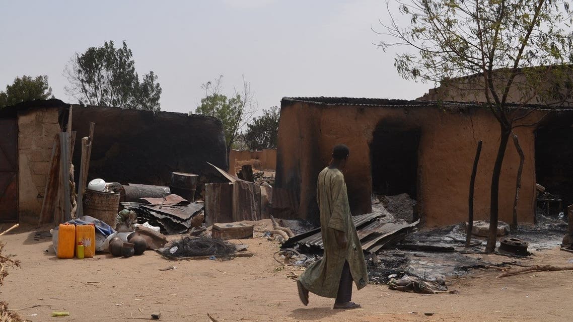 A villager walks past razed homes in Mainok, outside Maiduguri, Borno State, Nigeria. (File photo: AFP)