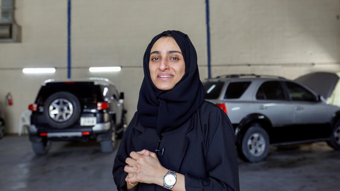 Huda al-Matrooshi, 36, an Emirati woman who owns and runs a car repair garage, checks a car at her garage in Sharjah, United Arab Emirates April 21, 2021. (Reuters)