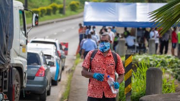 This picture taken on April 26, 2021 shows security officers checking cars along a road in Suva after the Fijian capital entered a 14-day lockdown following a COVID-19 spike following a superspreader funeral event. (AFP)