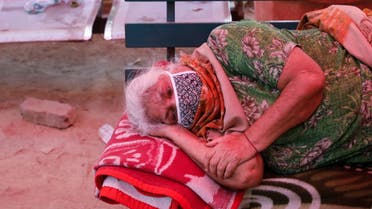 A woman suffering from a breathing difficulty due to the coronavirus disease (COVID-19) waits to receive oxygen support for free outside a Gurudwara (Sikh temple) in Ghaziabad, India, April 27, 2021. REUTERS/Adnan Abidi