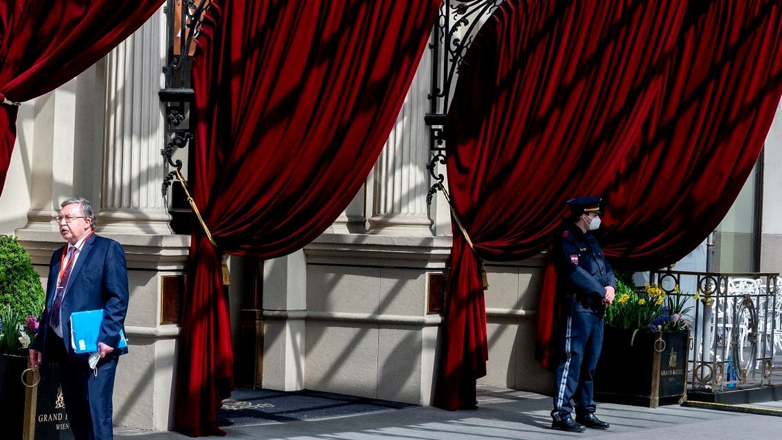 Russia's envoy to the IAEA, Mikhail Ulyanov (L) stands outside to the 'Grand Hotel Wien' for the closed-door nuclear talks with Iran in Vienna, April 27, 2021. (AFP)