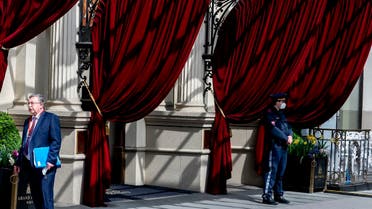 Russia's envoy to the IAEA, Mikhail Ulyanov (L) stands outside to the 'Grand Hotel Wien' for the closed-door nuclear talks with Iran in Vienna, April 27, 2021. (AFP)