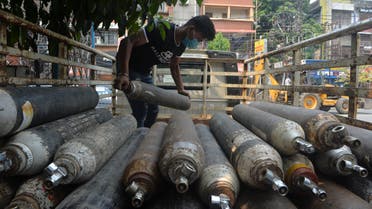 A man unloads empty oxygen cylinders for refill at an oxygen supply agency amidst rising Covid-19 coronavirus cases, in Siliguri on April 28, 2021. (File photo: AFP)