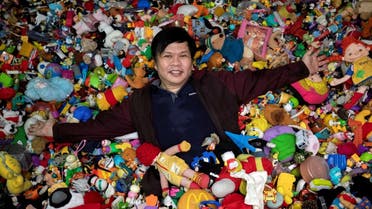 Percival Lugue, who has the Guinness world record for the largest fast-food toy collection, poses with his toy collection in his home in Apalit, Pampanga province, Philippines, on April 20, 2021. (Reuters)