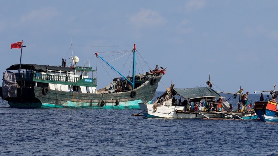 A Chinese fishing vessel is anchored next to Filipino fishing boats at the disputed Scarborough Shoal. (File photo: Reuters)