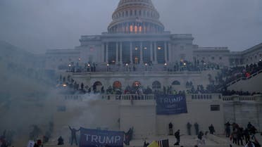 Police officers stand guard as supporters of US President Donald Trump gather in front of the US Capitol Building in Washington, US, January 6, 2021. (Reuters)