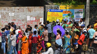 People gather outside an entrance gate of a Covid-19 coronavirus vaccination centre in Mumbai on April 28, 2021. (File photo: AFP)