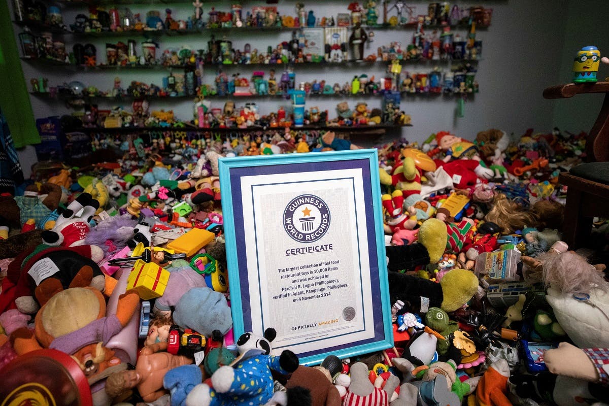 Percival Lugue’s certificate for the Guinness world record for the largest fast-food toy collection is photographed with his toy collection in his home in Apalit, Pampanga province, Philippines. (Reuters)