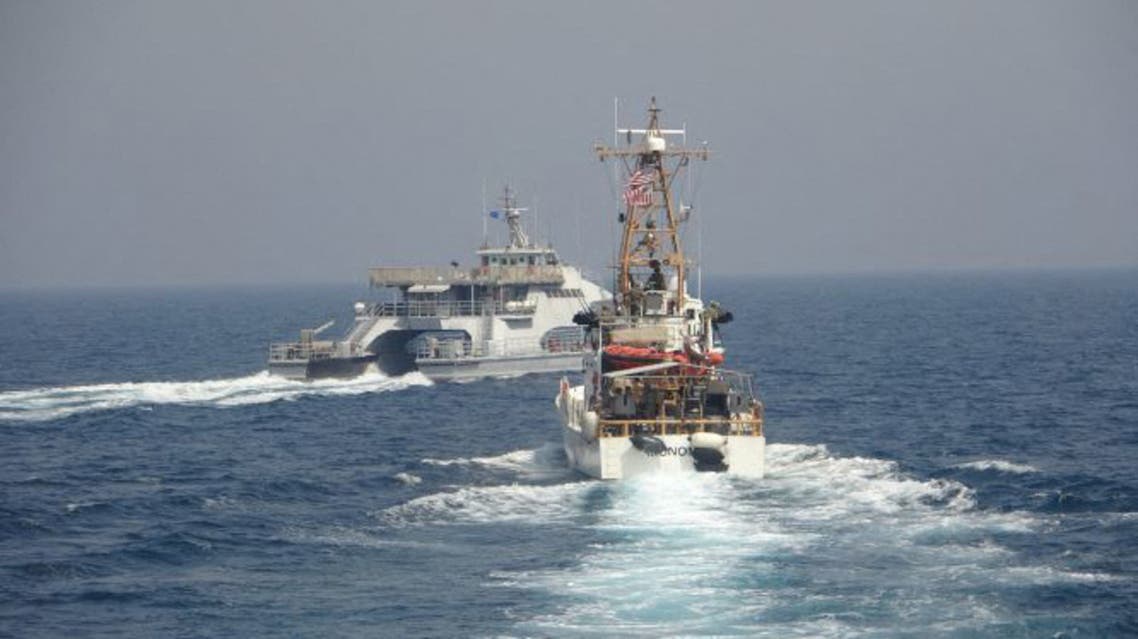 In this handout photo courtesy of US Navy Iran’s Islamic Revolutionary Guard Corps Navy (IRGCN) Harth 55 (L) conducted an unsafe and unprofessional action by crossing the bow of the Coast Guard patrol boat USCGC Monomoy (WPB 1326) (R) as the US vessel was conducting a routine maritime security patrol in international waters of the southern Arabian Gulf, April 2, 2021. The USCGC ships are assigned to Patrol Forces Southwest Asia (PATFORSWA), the largest US Coast Guard unit outside the United States, and operate under U.S. Naval Forces Central Command’s Task Force 55.