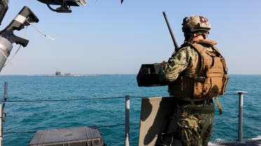 A United States Navy, security personnal stands watch oboard a Mark VI patrol boat while escorting the guided-missile submarine USS Georgia (SSGN 729) through the Gulf, outbound from a sustainment and logistics visit in Manama, Bahrain, in this picture taken December 23, 2020 and released by U.S. Navy (Fifth-Fleet) on December 31, 2020. Spc. Tradale Bryant/U.S. Naval Forces Central Comman/Handout via REUTERS ATTENTION EDITORS- THIS IMAGE HAS BEEN SUPPLIED BY A THIRD PARTY.