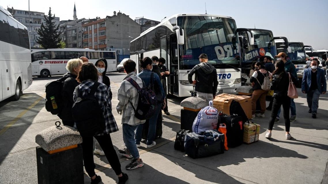 Travellers wait to board their buses as they leave the city from the Esenler national bus station in Istanbul on April 29, 2021, 12 hours ahead of a new full lockdown aiming at fighting a surging third wave of Covid-19, coronavirus infections. (AFP)