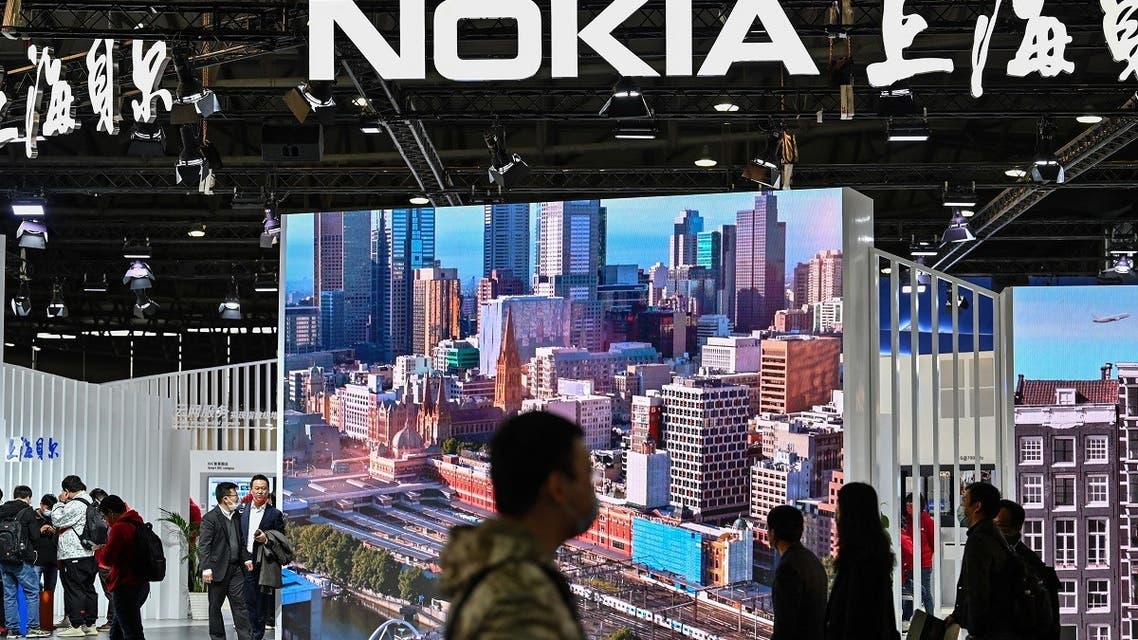 People walk past the Nokia booth during the Mobile World Congress in Shanghai on February 23, 2021. (AFP)