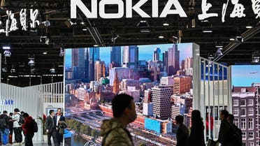 People walk past the Nokia booth during the Mobile World Congress in Shanghai on February 23, 2021. (AFP)
