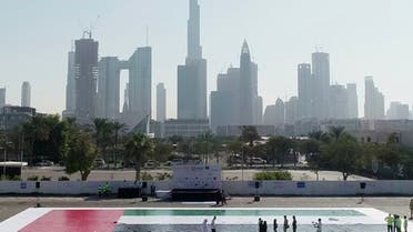 A UAE mosaic flag measuring 498.33 m² breaking a Guiness World Record with Dubai's skyline in the background. (WAM)