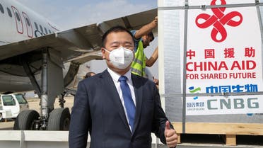 A member of the Chinese delegation gestures as a batch of China's Sinopharm COVID-19 vaccine arrives as a donation at the airport in Damascus, Syria April 24, 2021.  (Reuters)