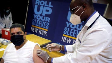 FILE PHOTO: Eugenio Brito, vice president of Bodegas of America, receives a Pfizer vaccination shot amid the coronavirus disease (COVID-19) pandemic, in the Harlem section of Manhattan in New York City, New York, U.S., April 23, 2021. REUTERS/Mike Segar/Pool/File Photo