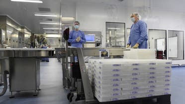 Employees are at work at the factory of US multinational pharmaceutical company Pfizer in Puurs. (AFP)