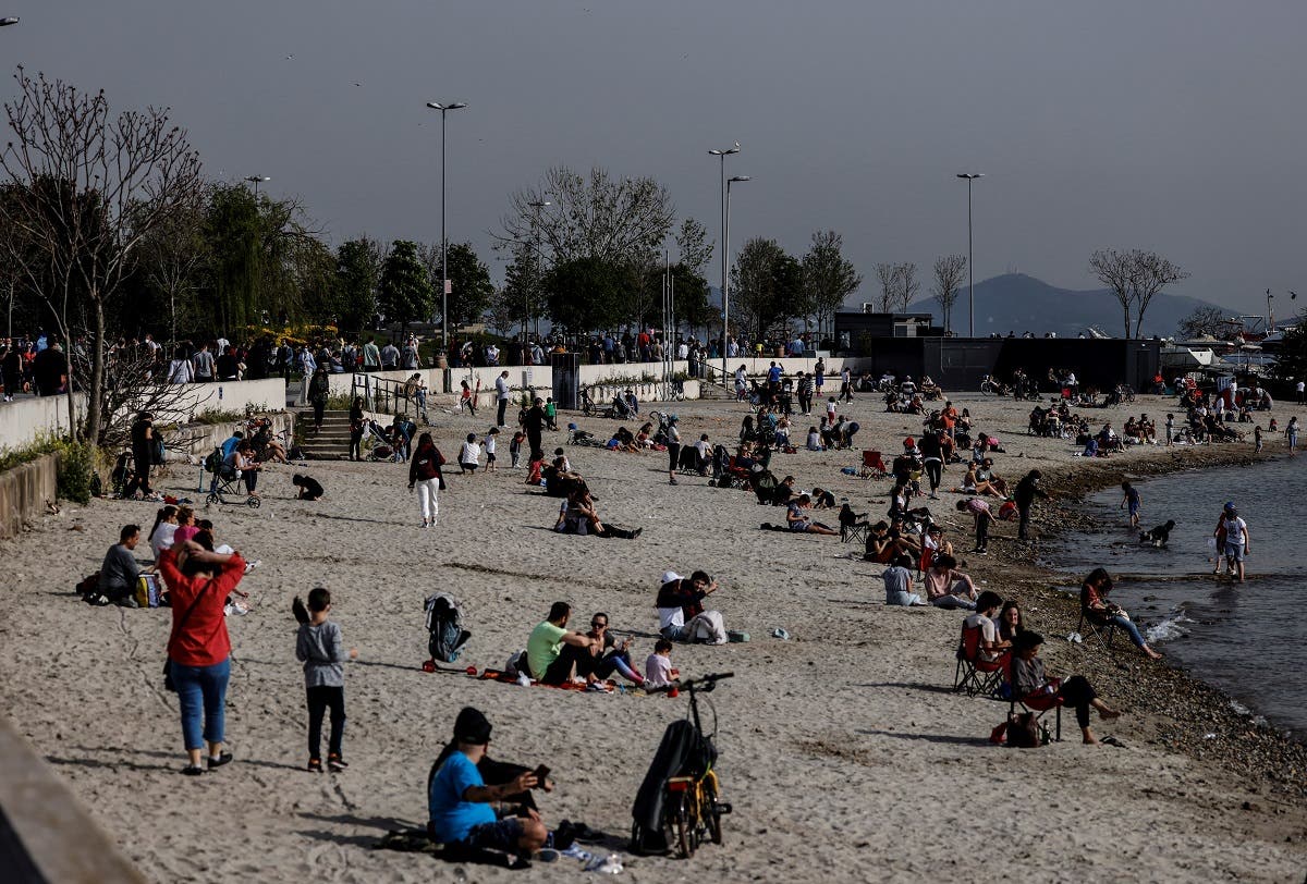 People enjoy a warm and sunny day the beach a few hours before the start of a nationwide “full closure” until May 17 including a continuous lockdown amid the spread of the coronavirus disease (COVID-19), in Istanbul, Turkey, on April 29, 2021. (Reuters)