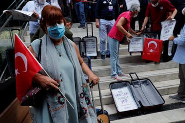 Travel agency owners display empty suitcases following a press statement demanding government's financial support for the tourism business as the spread of the coronavirus continues, in Istanbul, Turkey, on October 6, 2020. (Reuters)