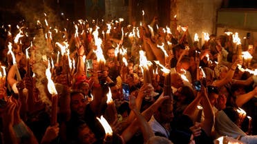 Orthodox Christian worshippers attend the Holy Fire ceremony amid eased coronavirus restrictions at the Church of the Holy Sepulchre in Jerusalem’s Old City, May 1, 2021. (Reuters/Corinna Kern)