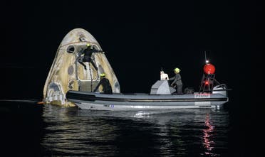 This handout image courtesy of NASA and made available on May 2, 2021, shows the support teams working around the SpaceX Crew Dragon Resilience spacecraft shortly after it landed with NASA astronauts Mike Hopkins, Shannon Walker, and Victor Glover, and Japan Aerospace Exploration Agency (JAXA) astronaut Soichi Noguchi aboard in the Gulf of Mexico off the coast of Panama City, Florida on May 2, 2021. (AFP)