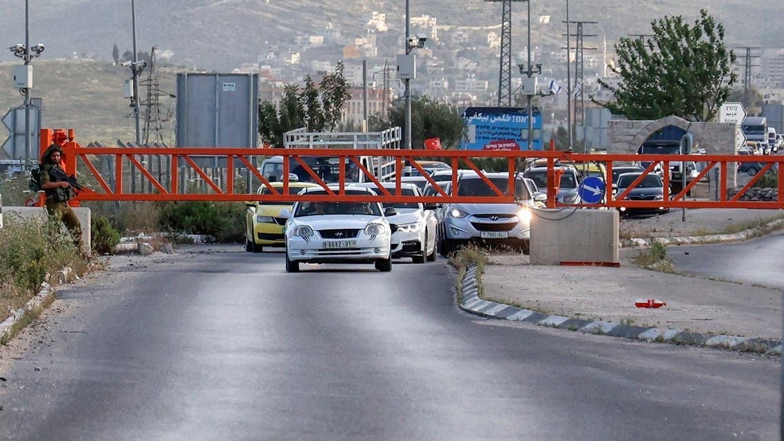 Israeli soldiers stand guard after closing the entrance of Nablus city in the occupied West Bank, on May 2, 2021, following a reported attack. (Jaafar Ashtiyeh /AFP)