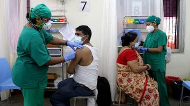 Rohit Gupta, 27 and Nandani Gupta, 42, receive their first dose of COVISHIELD, a coronavirus disease (COVID-19) vaccine manufactured by Serum Institute of India, at a vaccination center in Mumbai, India, on May 3, 2021. (Reuters)