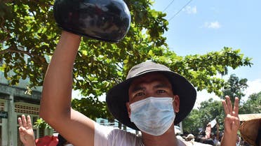 This handout photo taken and released by Dawei Watch on May 2, 2021 shows a protester holding an overturned alms bowl while taking part in a demonstration against the military coup on Global Myanmar Spring Revolution Day in Dawei. (File photo: AFP)