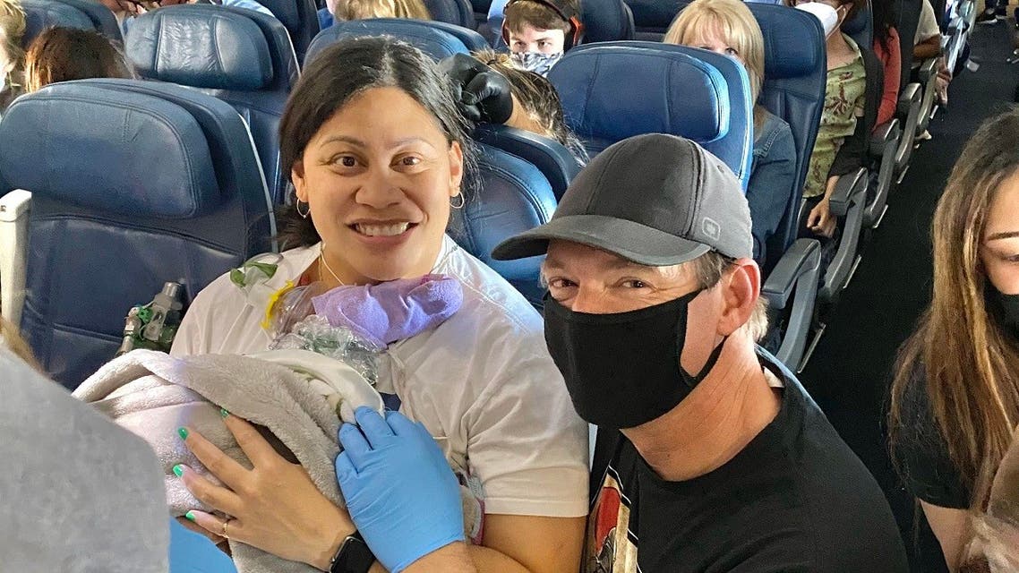 A doctor and a team of neonatal medical professionals help a pregnant woman deliver her baby mid-flight. (Twitter)