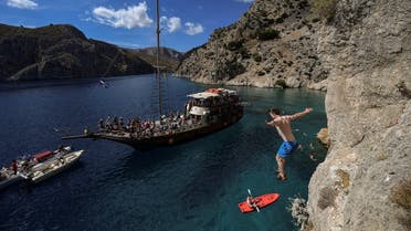 A climber jumps into the sea as he participates in the 2019 annual Climbing Festival in the island of Kalymnos on October 4, 2019. (Aris Messinis/AFP)
