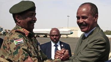 President of the Sudanese Transitional Council General Abdel Fattah al-Burhan (L) shakes hands with Eritrean President Isaias Afwerki at Khartoum International Airport outside the Sudanese capital September 14, 2019. (AFP)