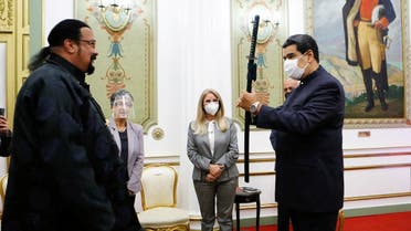 Venezuela’s President Nicolas Maduro (R) receives a samurai sword as a gift from actor Steven Seagal, who was visiting Venezuela as a representative of Russia, in Caracas, Venezuela May 4, 2021. (Miraflores Palace/Zurimar Campos/Handout via Reuters)