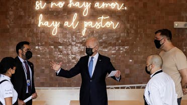 US President Joe Biden stands under a sign reading “if there is no love, there is still al pastor (tacos)” while being greeted as he visits Las Gemelas Taqueria in the Union Market neighborhood in Washington, US, on May 5, 2021. (Reuters)