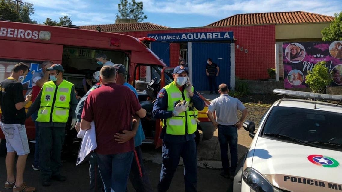 Photo released by Brazilian newspaper Imprensa do Povo showing people and local authorities at the surroundings of the Aquarela Daycare School, at the southern city of Saudades, Santa Catarina state, Brazil, on May 4, 20121. (Jocimar Barbosa/Impresa do Povo/AFP)
