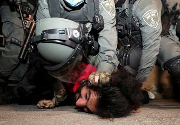 A Palestinian protester is detained by Israeli border policemen during clashes in the Sheikh Jarrah neighborhood of east Jerusalem May 4, 2021. (Reuters)