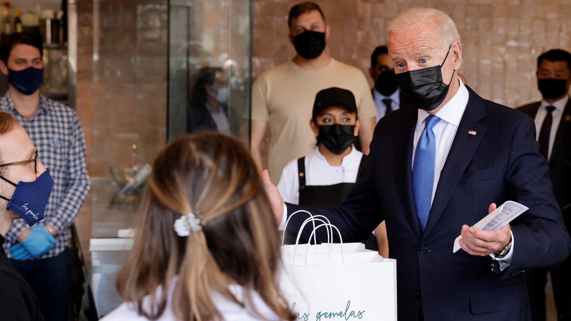 U.S. President Joe Biden speaks with the staff as he visits the Las Gemelas Taqueria restaurant for carry-out lunch on Cinco de Mayo in the Union Market neighborhood in Washington, U.S., May 5, 2021. REUTERS/Jonathan Ernst