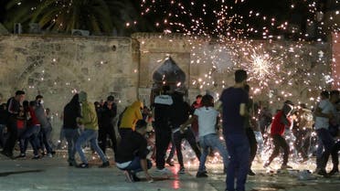 Palestinians react as Israeli police fire stun grenades during clashes at the compound that houses Al-Aqsa Mosque, May 7, 2021. (Reuters)
