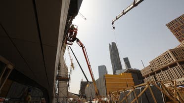 Laborers work on the exterior of the King Abdullah Financial District station during an exclusive tour of the Riyadh Metro on April 1, 2021 in the Saudi capital. (AFP)