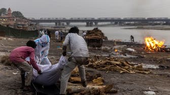 India’s COVID-19 corpses caught with net stretched across Ganges