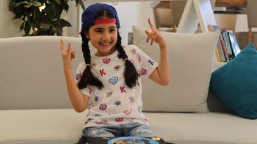Michelle Rasul flashes a rockstar sign in the lobby of her apartment building in Dubai, United Arab Emirates, Sunday, May 9, 2021. Rasul, a 9-year-old girl from Azerbaijan who lives in Dubai, is scratching her way to the top as a DJ after competing in the DMC World DJ Championship. (AP)