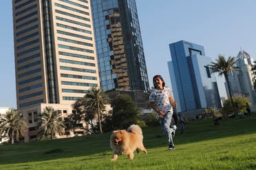  Michelle Rasul chases a friend's dog at a park near her house in Dubai, United Arab Emirates, Sunday, May 9, 2021. Rasul, a 9-year-old girl from Azerbaijan who lives in Dubai, is scratching her way to the top as a DJ after competing in the DMC World DJ Championship. (AP)