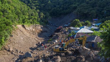 An aerial picture shows an excavator search for a body at an area affected by landslides triggered by tropical cyclone Seroja in Lembata, East Nusa Tenggara province, Indonesia April 10, 2021. (Reuters)