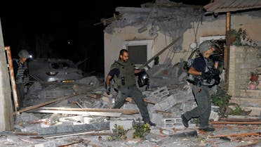 Israeli firefighters and security forces inspect damages at a house in Yehud, near Tel Aviv, on May 12, 2021, after rockets were launched towards Israel from the Gaza Strip controlled by the Palestinian militant group Hamas. Palestinian militant group Hamas said on May 12 it had fired more than 200 rockets into Israel in retaliation for strikes on a tower block in Gaza. (File photo: AFP)