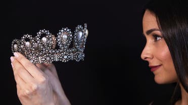 A staff holds a diamond and pearl tiara passed down through generations of the Italian royal family during a preview at Sotheby's before their auction in Geneva, Switzerland, May 6, 2021. REUTERS/Denis Balibouse