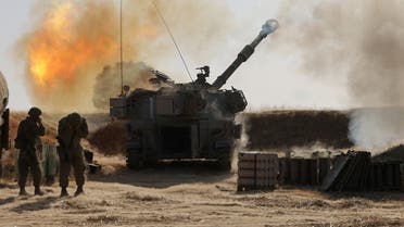 Israeli soldiers fire a 155mm self-propelled howitzer toward targets in the Gaza Strip from their position near the southern Israeli city of Sderot on May 12, 2021. (Menahem Kahana/AFP)