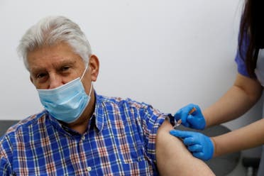 An elderly person receives a dose of the Oxford/AstraZeneca COVID-19 vaccine at Cullimore Chemist, in Edgware, London. (File photo: Reuters)