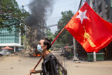  A man holds a National League for Democracy (NLD) flag during a protest against the military coup, in Yangon, Myanmar March 27, 2021. (File Photo: Reuters)