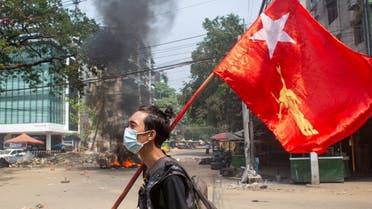 FILE PHOTO: A man holds a National League for Democracy (NLD) flag during a protest against the military coup, in Yangon, Myanmar March 27, 2021. (File Photo: Reuters)