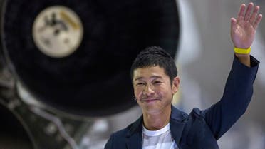 Japanese billionaire Yusaku Maezawa gestures near a Falcon 9 rocket during the announcement by Elon Musk to be the first private passenger who will fly around the Moon aboard the SpaceX BFR launch vehicle, at the SpaceX headquarters and rocket factory in Hawthorne, California. (AFP)